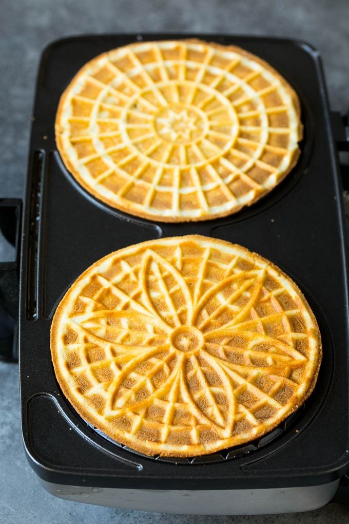 Baked cookies inside a pizzelle iron.