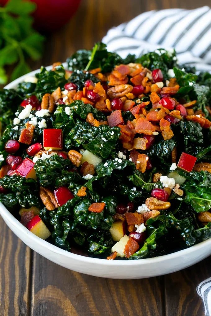 Apple kale salad topped with bacon and pecans.