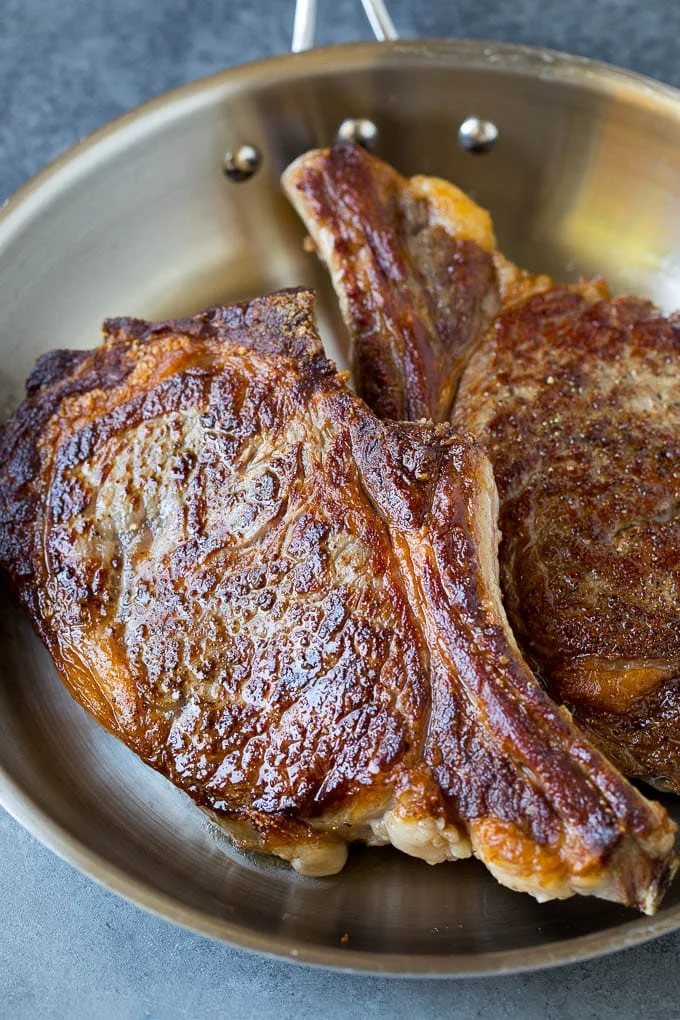 Seared steaks in a skillet.