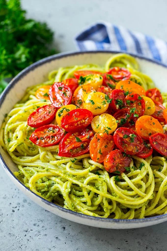 Pesto pasta topped with roasted cherry tomatoes.