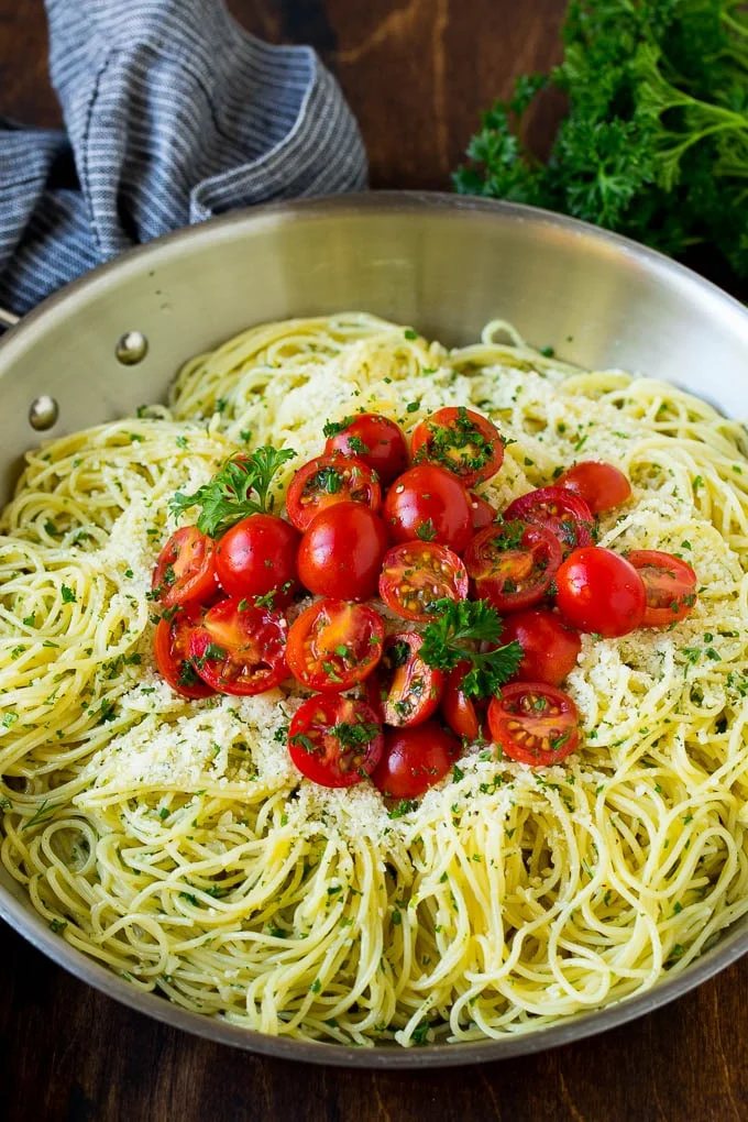 Garlic and herb angel hair pasta topped with fresh tomatoes.