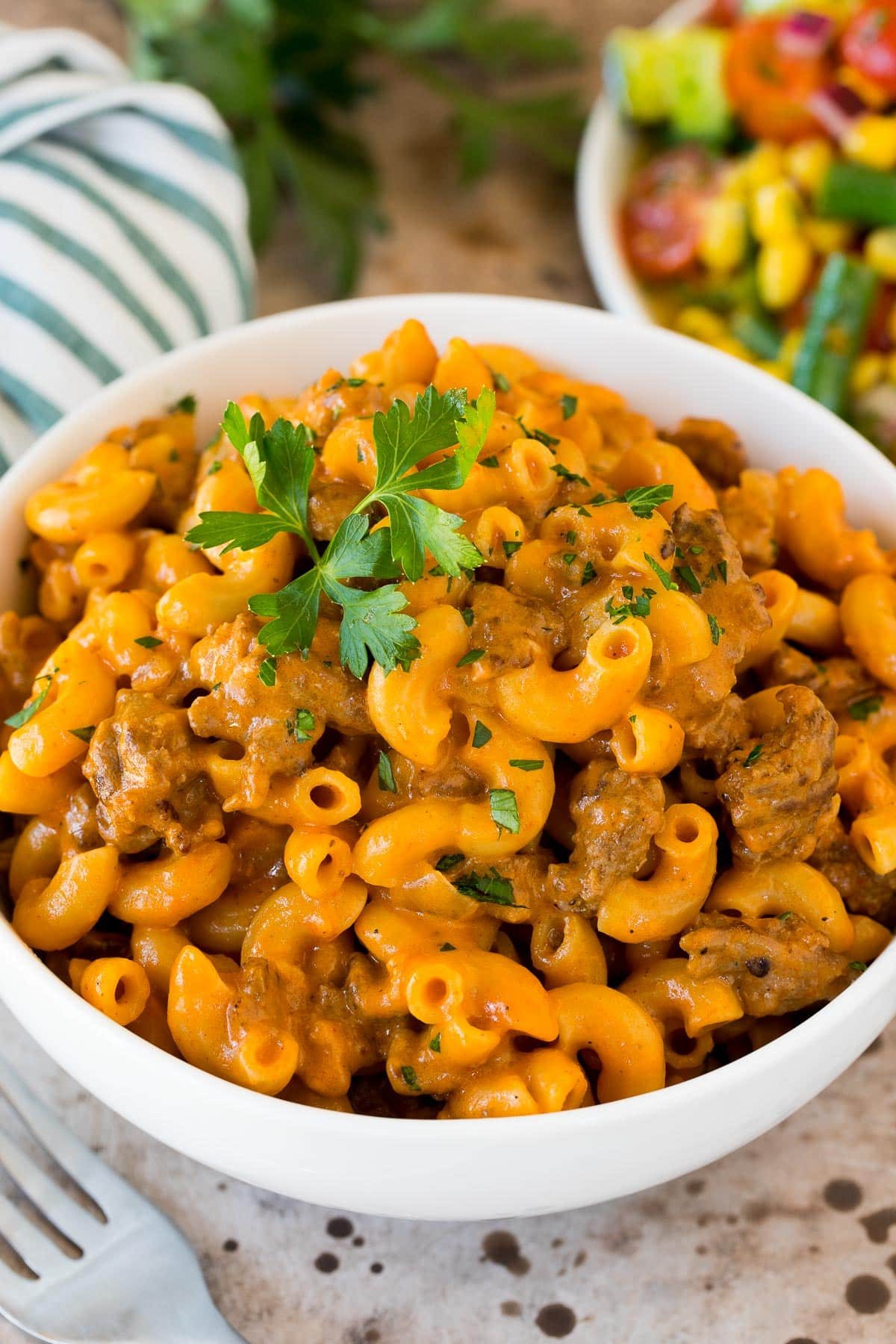 A bowl of kitchen-made hamburger helper topped with parsley.