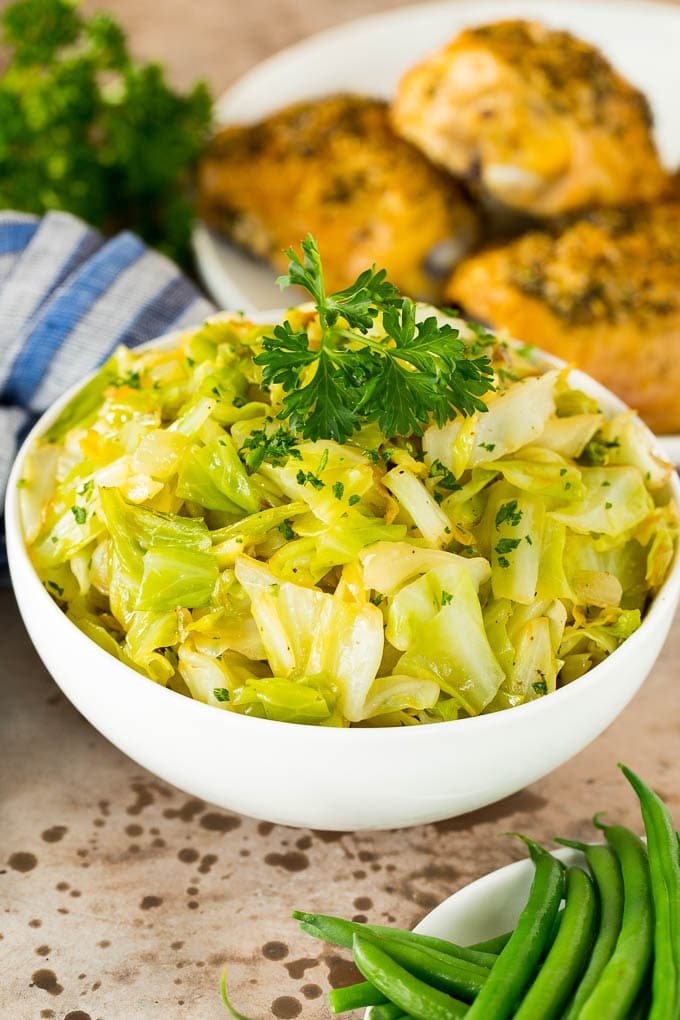 A bowl of sauteed cabbage topped with parsley.