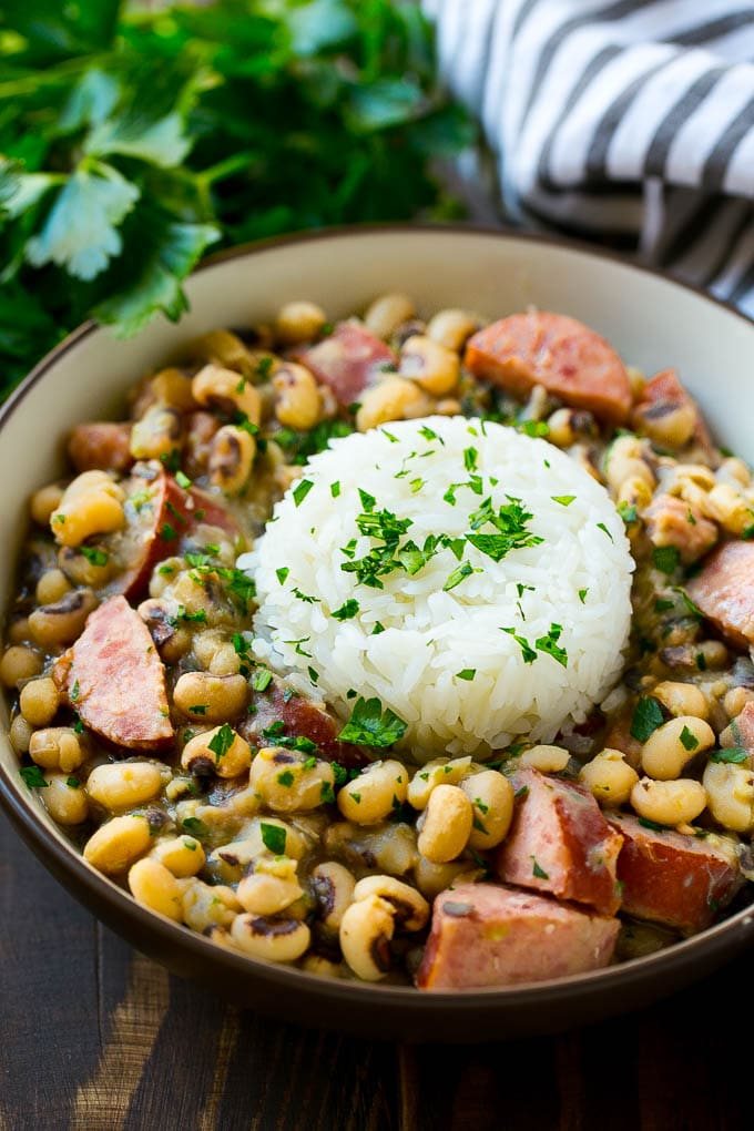 A bowl of slow cooker black eyed peas with a scoop of rice.