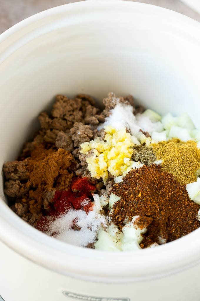 Ground beef, onions and spices in a crock pot.