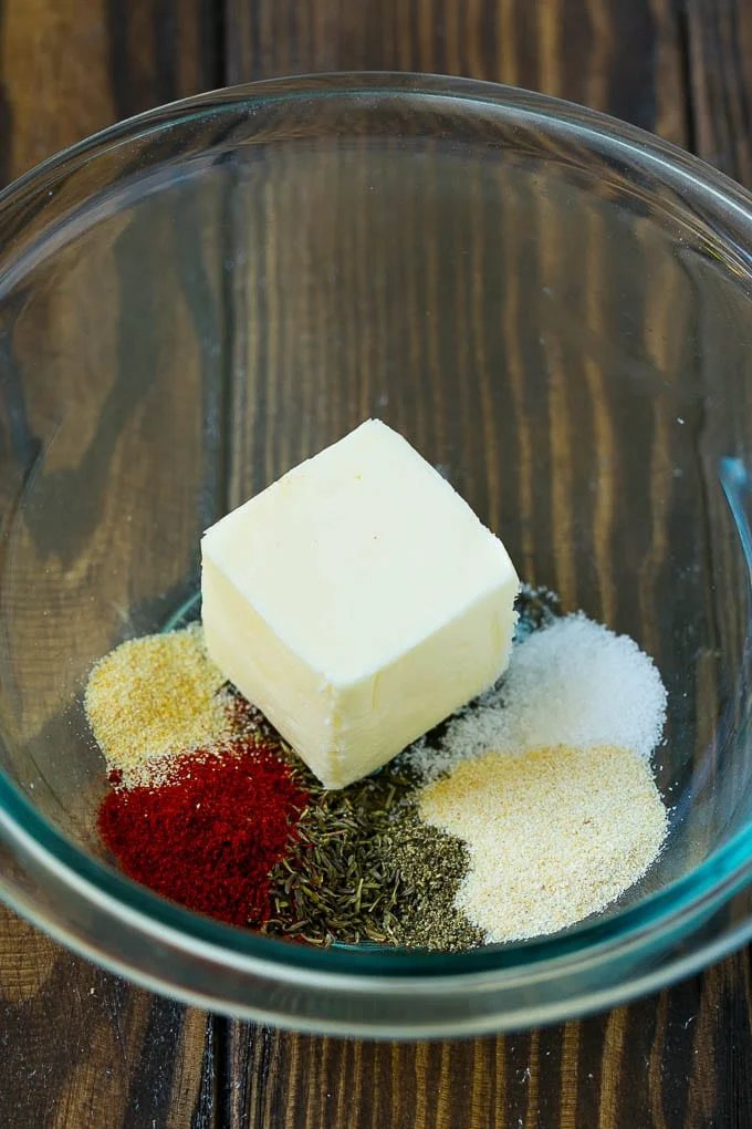 Butter and seasonings in a mixing bowl.