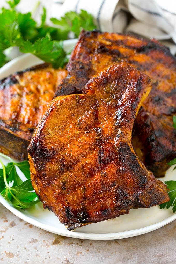 A plate of smoked pork chops garnished with fresh parsley.