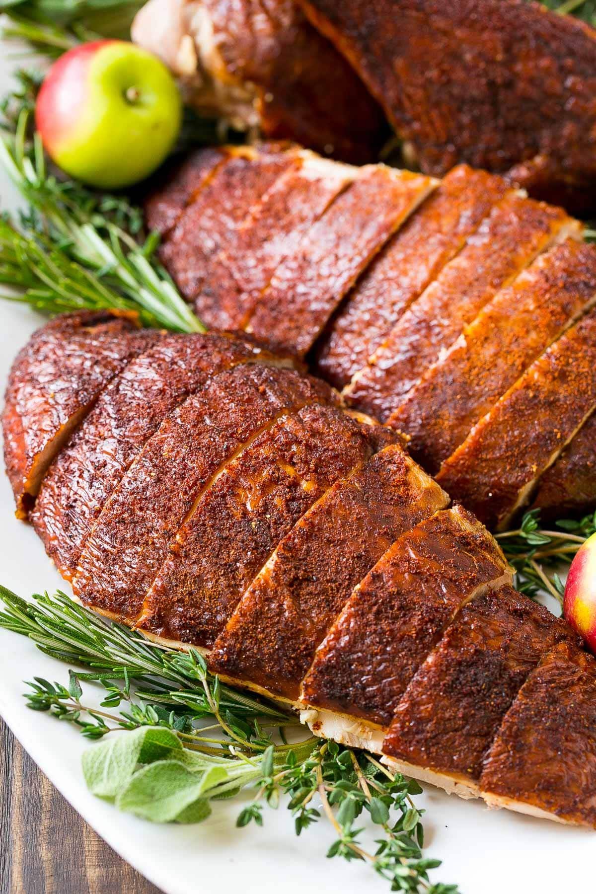 Sliced smoked turkey breast on a plate.