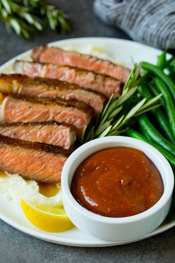 Kitchen-made steak sauce served with sliced steak and green beans.