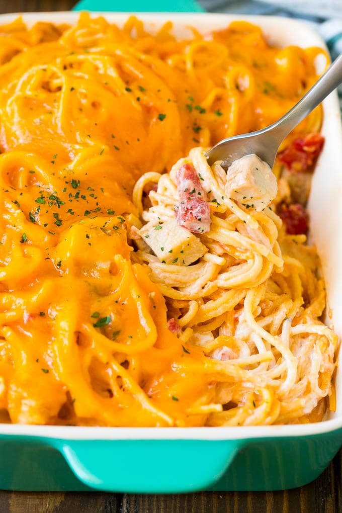 A fork serving up a portion of silky chicken spaghetti.