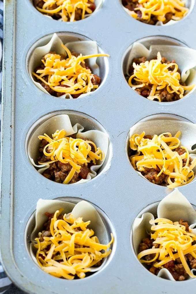 Layers of meat and shredded cheese are combined with wontons then baked.