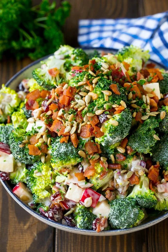 Broccoli salad in a silky dressing topped with sunflower seeds and bacon.