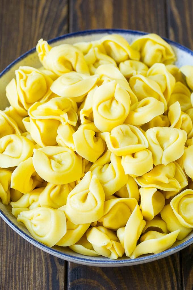 A bowl of cooked cheese tortellini.