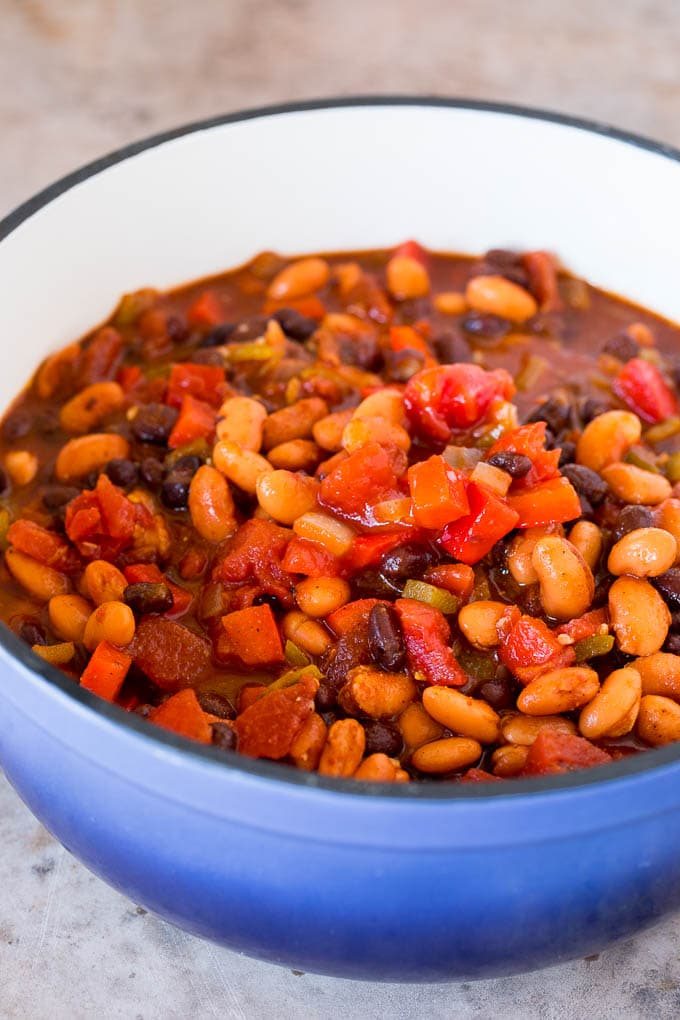 Beans, peppers, onions and tomatoes in a soup pot.