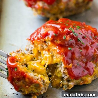 The Ultimate Burger Bake 3 A cheeseburger meatloaf with a fork pulling a piece away.