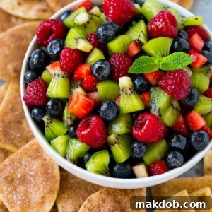 A vibrant bowl of fresh fruit salsa, artfully served with crispy cinnamon sugar chips.