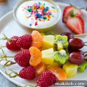 This recipe for fruit kabobs creates a beautiful rainbow of fresh fruit served on skewers with a creamy yogurt dipping sauce, making healthy eating fun and appealing.