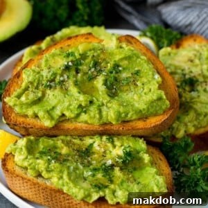A plate of perfectly prepared avocado toast, garnished with fresh parsley.