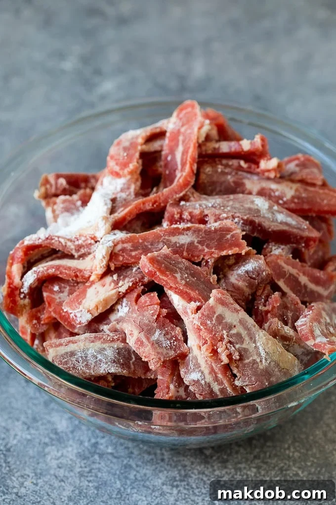 Mongolian Beef Recipe | Asian Beef Recipe | Chinese Beef | Beef Stir Fry #Chinese #Mongolian #Asian #mongolianbeef #beef #dinneratthezoo #dinner Thinly sliced flank steak coated in cornstarch, ready for searing.