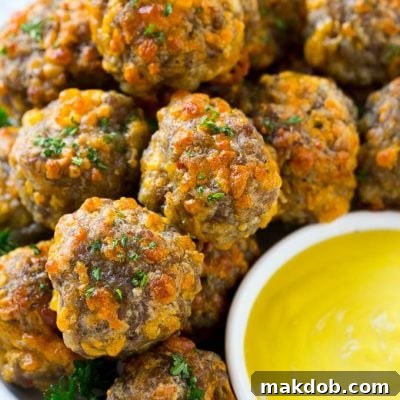 Savory Sausage Cheese Bites 2 A platter of sausage cheese balls with honey mustard sauce for dipping.