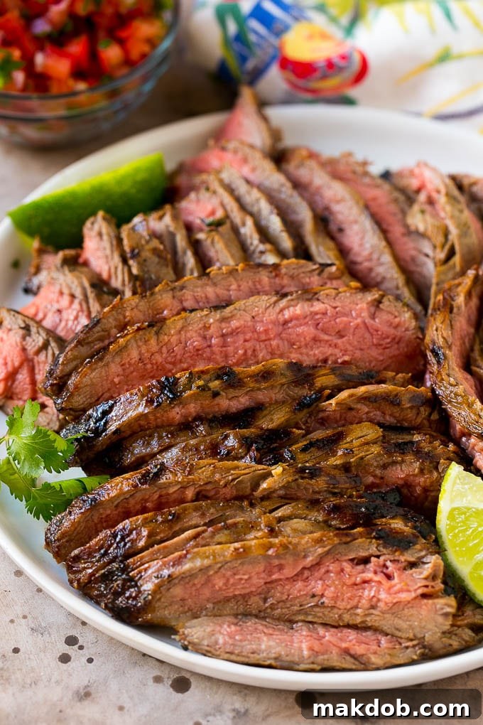 Sizzling Carne Asada Tacos 5 Thinly sliced carne asada steak arranged on a serving plate, ready to be added to tacos.