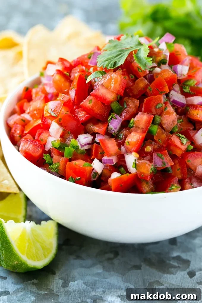 Vibrant Homemade Pico de Gallo 3 A beautiful bowl of homemade pico de gallo, surrounded by golden tortilla chips, inviting a taste.