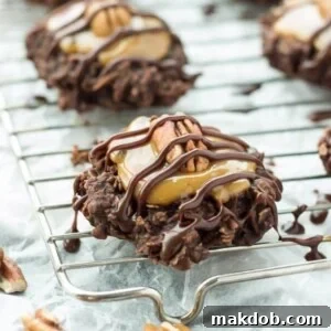 18 Effortless No-Bake Cookie Delights 21 An image of luxurious no-bake turtle cookies arranged on a wire cooling rack, highlighting their caramel and pecan toppings.