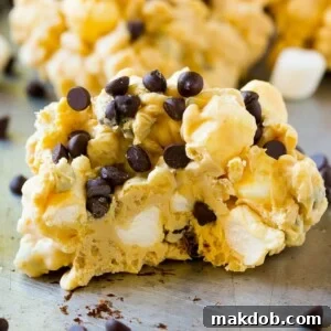 18 Effortless No-Bake Cookie Delights 4 A close up of an avalanche cookie with a bite taken out of it, showing the delicious layers of peanut butter, chocolate, and marshmallow.