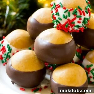 18 Effortless No-Bake Cookie Delights 5 Buckeye balls on a serving platter garnished with colorful sprinkles, showing their perfect chocolate coating and peanut butter center.