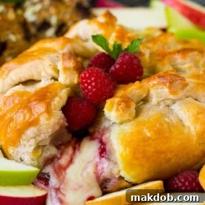 Baked brie cut open with cheese spilling out.