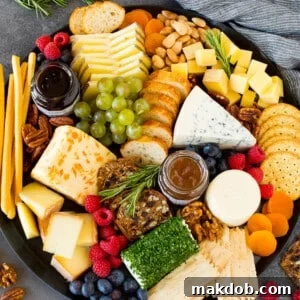 The best cheese board with assorted cheeses, bread, crackers, fruit and nuts.