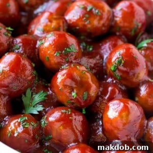 A crock pot full of cranberry meatballs.