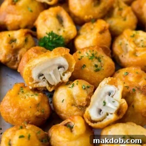 A sheet pan of fried mushrooms garnished with parsley.