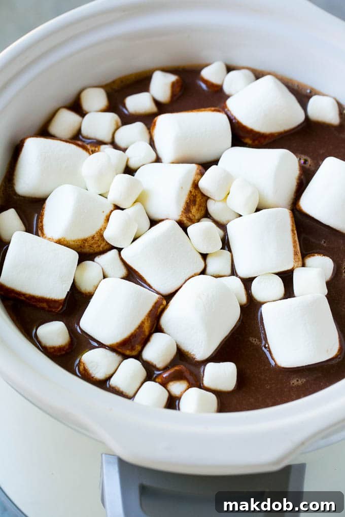 Slow Cooker Hot Chocolate Recipe | Homemade Hot Chocolate | Slow Cooker Hot Cocoa | Crock Pot Hot Chocolate #cocoa #hotchocolate #chocolate #slowcooker #crockpot #holiday #christmas #drink A delectable slow cooker hot chocolate topped with an assortment of fluffy marshmallows, ready for a cozy treat.