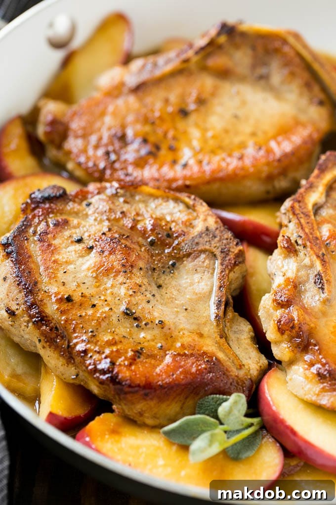 Apple Pork Chops Recipe | Pork Chops with Apples | Cider Pork Chops | Bone In Pork Chops Recipe #pork #porkchops #fall #apple #dinner #dinneratthezoo Seared pork in a pan in a sweet and savory sauce with fresh herbs.