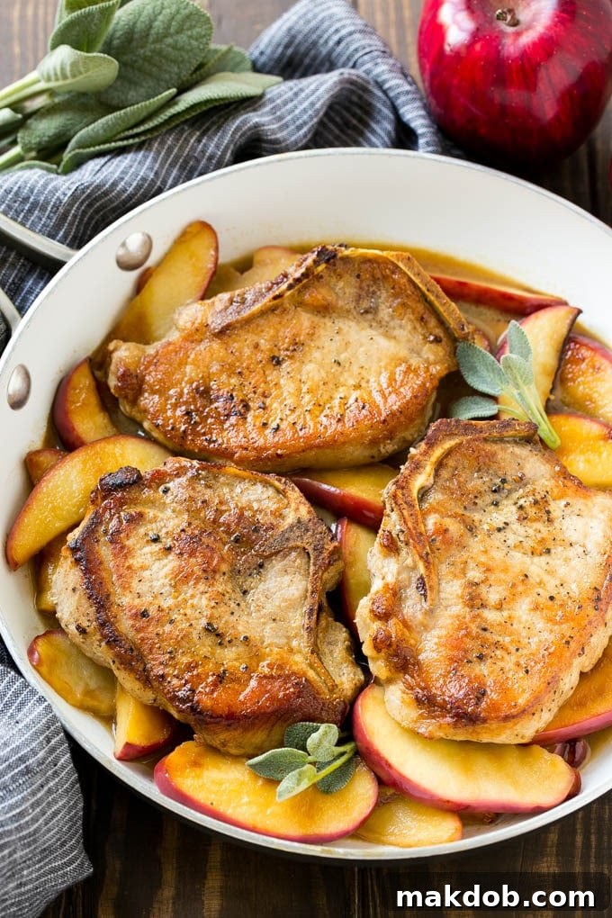 Apple Pork Chops Recipe | Pork Chops with Apples | Cider Pork Chops | Bone In Pork Chops Recipe #pork #porkchops #fall #apple #dinner #dinneratthezoo Apple pork chops with cider and sage in a skillet.