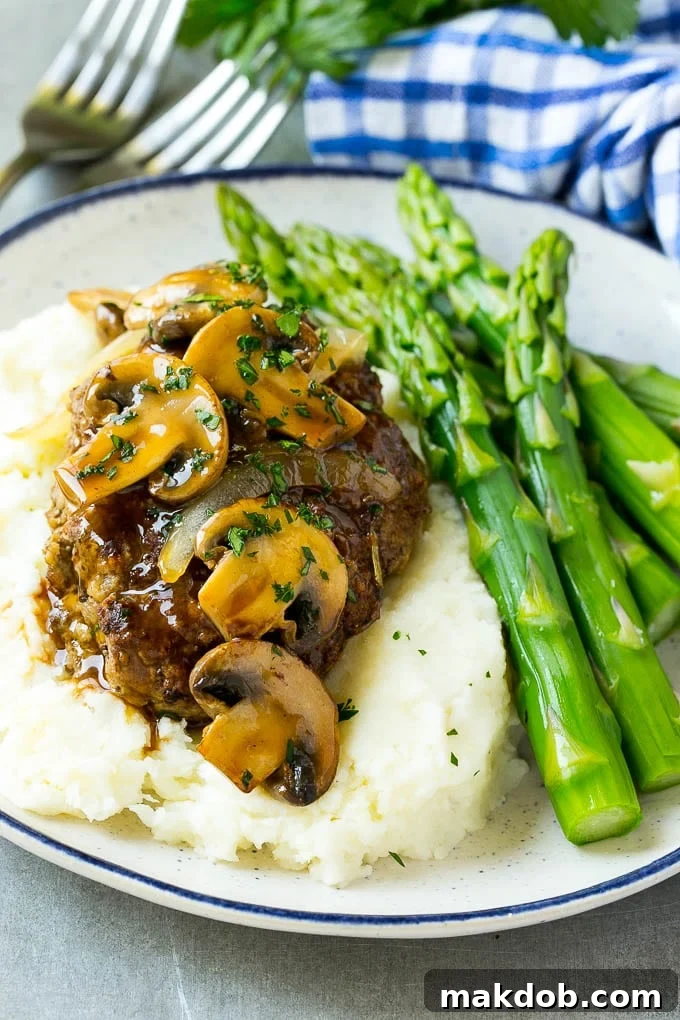 Slow Cooker Salisbury Steak Recipe | Homemade Salisbury Steak | Salisbury Steak from Scratch #steak #beef #salisbury #salisburysteak #slowcooker #crockpot #dinner #dinneratthezoo Slow cooker salisbury steak with mushroom gravy over mashed potatoes.