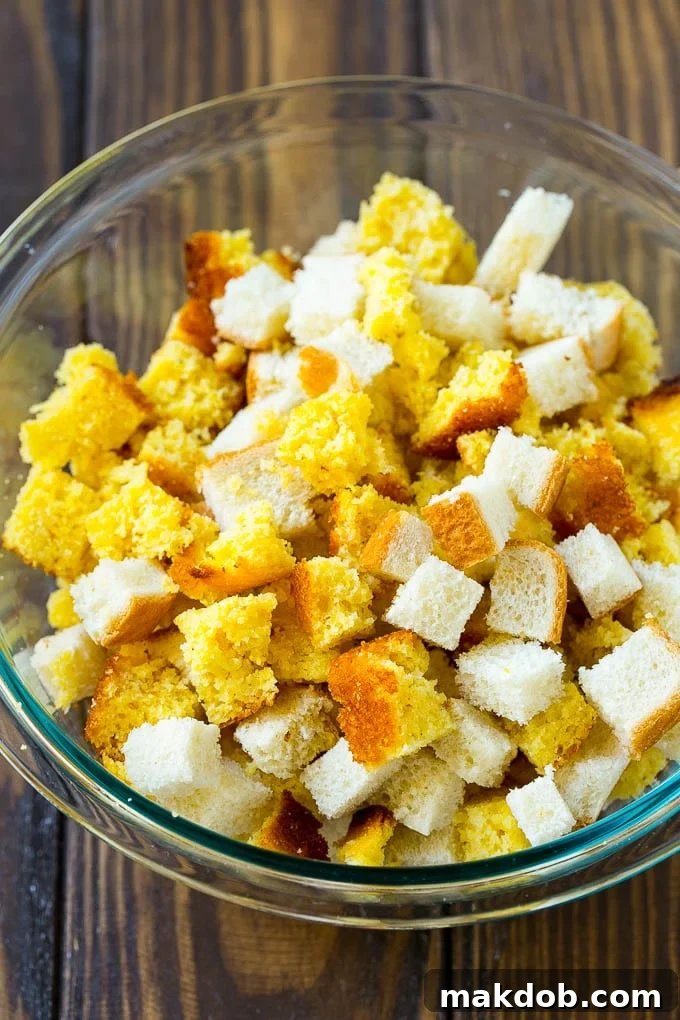 Grandma's Southern Cornbread Dressing 4 Cornbread and white bread cubes in a mixing bowl.