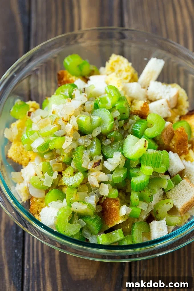 Grandma's Southern Cornbread Dressing 5 Bread cubes, cornbread and sauteed celery and onions in a bowl.