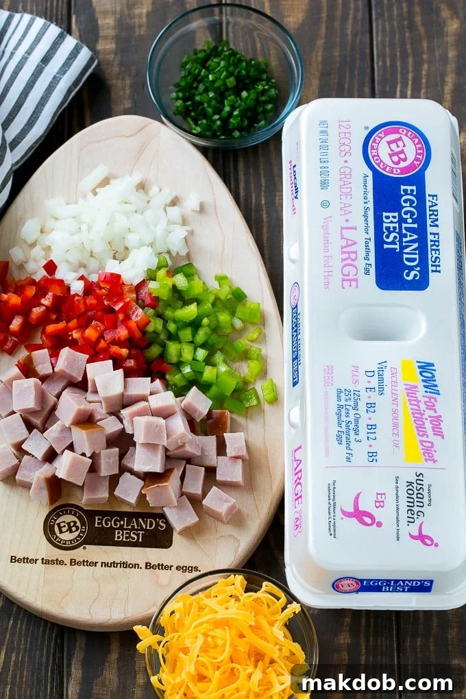 Fresh Ingredients for Hash Brown Egg Casserole | Ham, Eggs, Peppers, Onions, and Cheese for Breakfast Casserole A vibrant selection of ingredients laid out for the hash brown egg casserole, including fresh eggs, diced ham, colorful bell peppers, onions, and shredded cheese.
