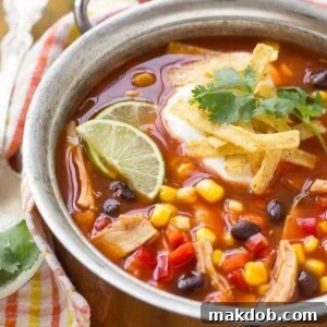 A hearty bowl of quick and easy chicken taco soup, brimming with beans and vegetables, ready in just 25 minutes.