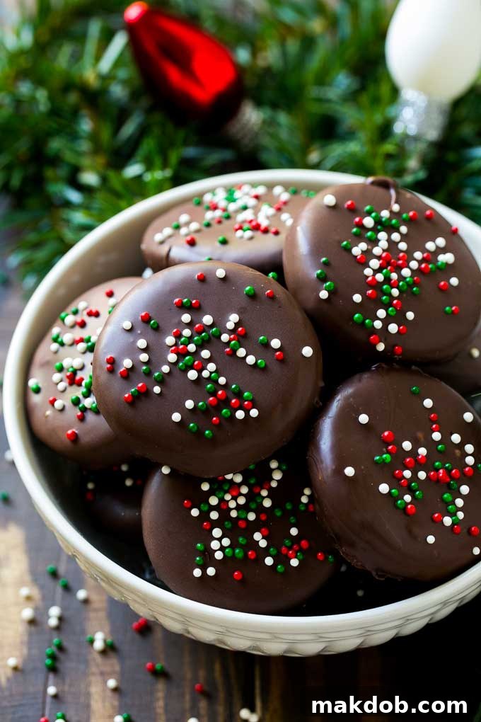 A bowl filled with copycat York peppermint patties, some topped with colorful holiday sprinkles.