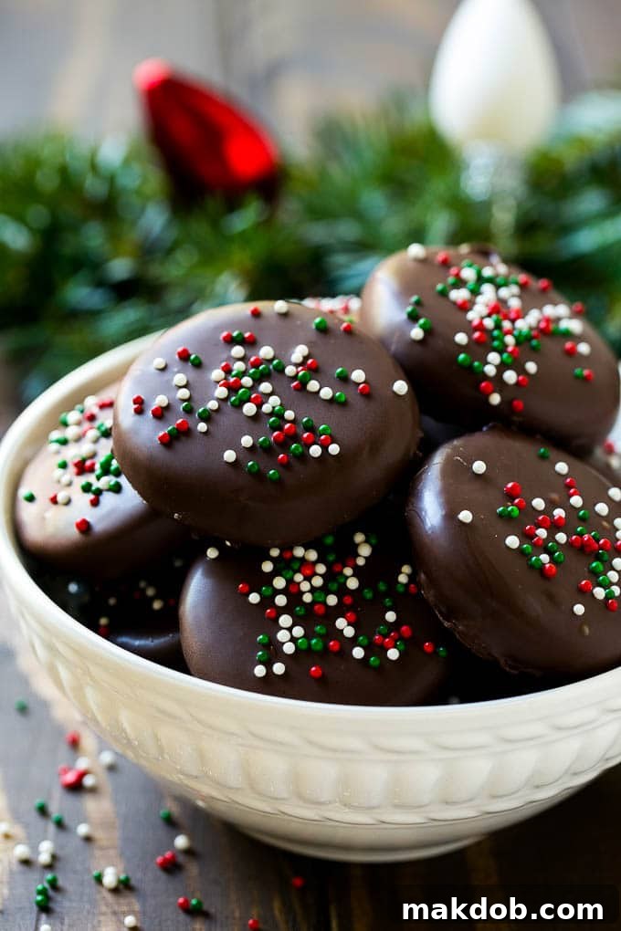 A white bowl filled with glossy, chocolate-covered peppermint patties ready to be enjoyed.
