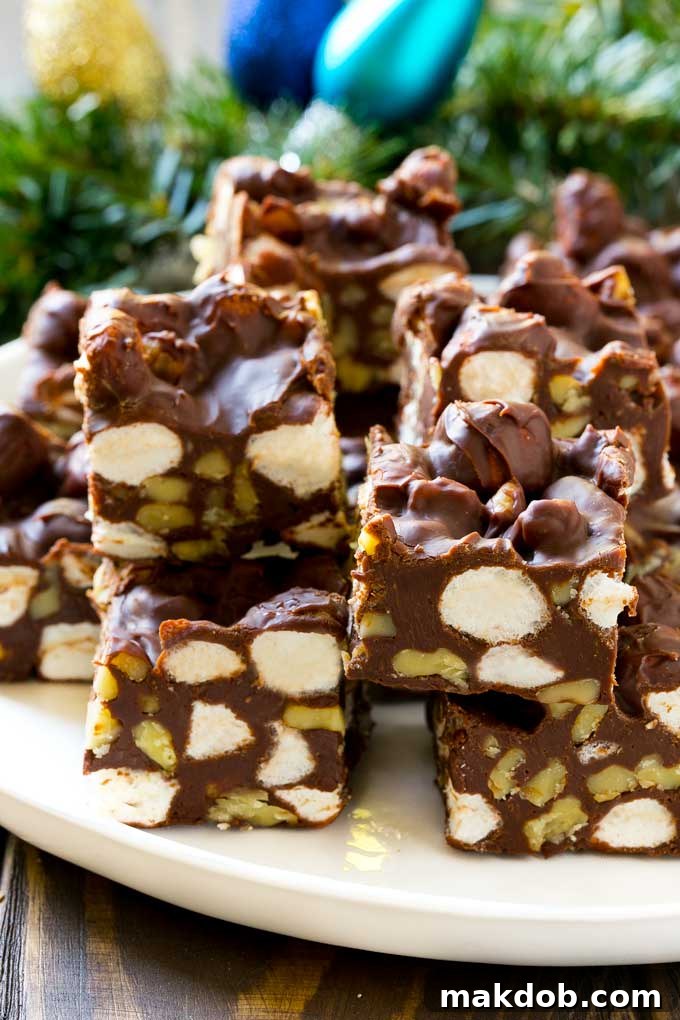 Rocky Road Fudge cut into squares on a serving plate.