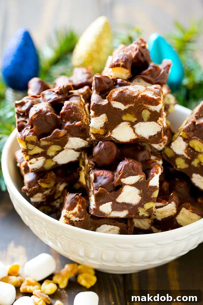 A bowl of fudge squares with holiday decorations in the background.