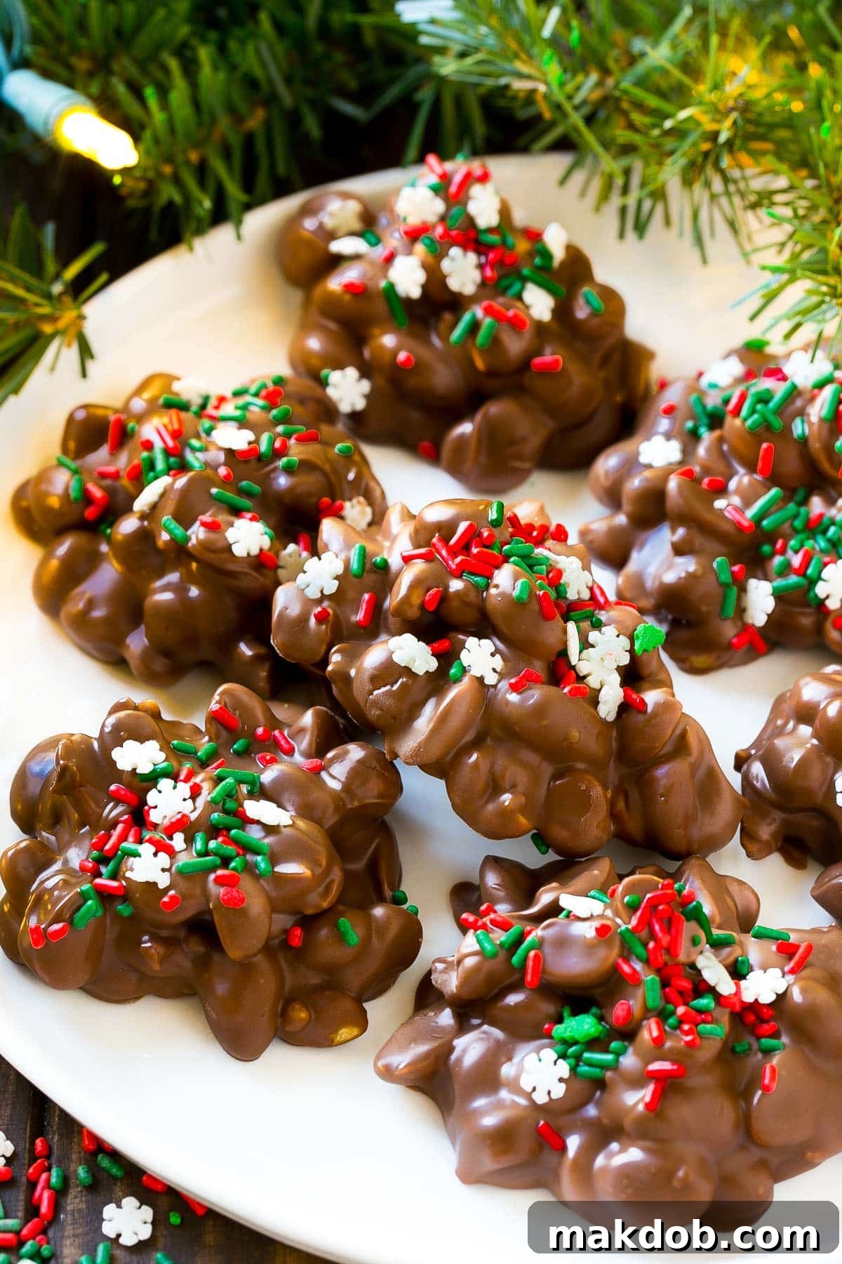 A simple plate adorned with several perfectly set chocolate peanut clusters, highlighting their appealing texture.