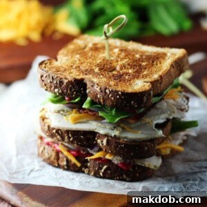 30 Creative Ways to Reinvent Leftover Turkey 12 An image of two turkey club sandwiches on a cutting board.