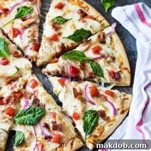 30 Creative Ways to Reinvent Leftover Turkey 19 A picture of turkey bacon ranch pizza cut in slices on a board.