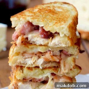 30 Creative Ways to Reinvent Leftover Turkey 21 A picture of three turkey, bacon and brie sandwiches stacked.