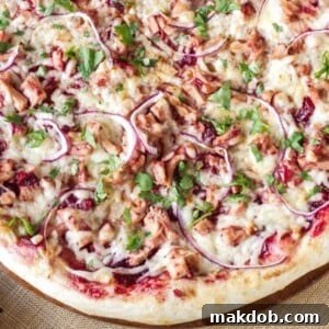 An image of a pizza with turkey and barbecue sauce toppings.